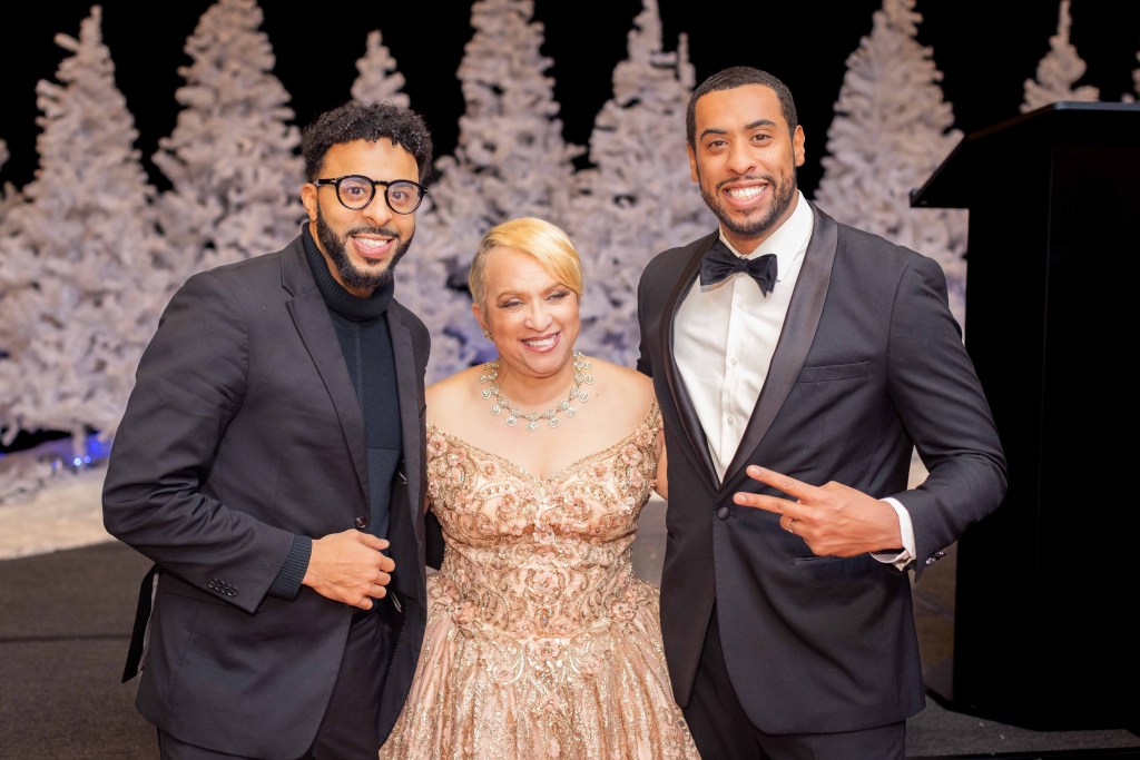 Dr. Maxine Cain, founder of STEM Atlanta Women, taking a photo with Gavin Delisser and Patrick Delisser of Omni Worldwide during the 2025 STEMii Awards corporate event